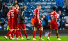 Left to right, Aberdeen's Alexander Jensen, Alfie Dorrington, Kristers Tobers and Shayden Morris look dejected at full-time following the Premiership defeat to Rangers at Ibrox. Image: SNS.