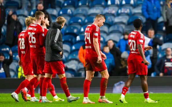 Left to right, Aberdeen's Alexander Jensen, Alfie Dorrington, Kristers Tobers and Shayden Morris look dejected at full-time following the Premiership defeat to Rangers at Ibrox. Image: SNS.