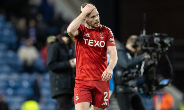 Aberdeen's Nicky Devlin looks dejected at full time after defeat to Rangers. Image: SNS.