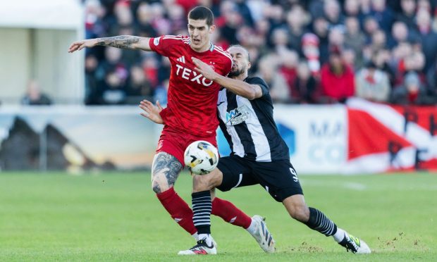 Elgin's Dajon Golding and Aberdeen's Sobodan Rubezic in action during a Scottish Cup fourth round tie. Image: SNS