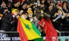 Aberdeen's Pape Gueye with fans at full time after the 3-0 win against Elgin City in the Scottish Cup. Image: SNS