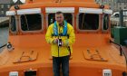 Kenneth Gee standing on the lifeboat