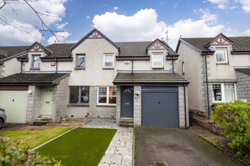 Number 61 Thorngrove Avenue has gardens to the front and rear and a single garage.