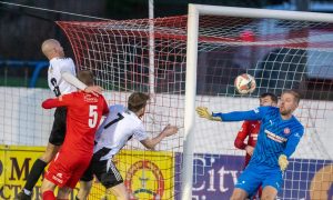 The ball going into the net for Fraserburgh's winning goal having come off Brora Rangers defender Mark Nicolson (number five, second from left). Pictures by Jasperimage.