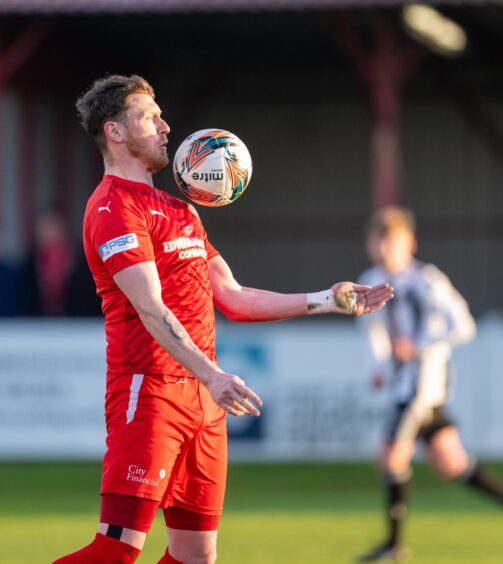 Shane Sutherland controls the ball with his chest in action for Brora Rangers.