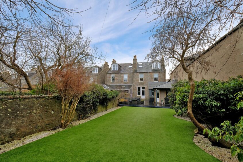 the long, enclosed garden with lawn 