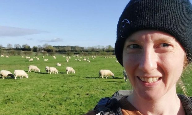 Claire Halliday selfie with field of sheep in background