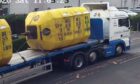 To go with story by Alan Richardson. . Picture shows; Colin Lawson Transport Ltd A92 death. Yellow container pic - CCTV image from 22 August 2020 showing the lorry prior to the accident. It was the front mooring buoy which came off the lorry. Blue pipe pic - CLT lorry post incident on 18 December 2020?. .. Supplied by Crown Office Date; Unknown