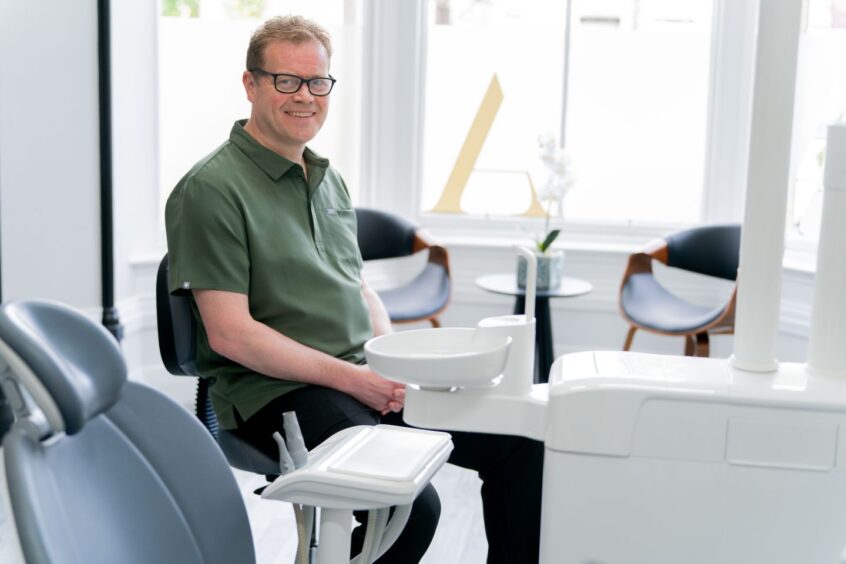 Andrew Scott sits in his clinic in Aberdeen