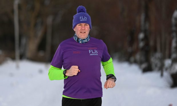 Rory Smith, pictured running in the snow, says the Fit Like Joggers running club changed his life.