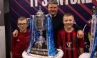 Fraserburgh manager Mark Cowie, centre, with two young Broch supporters and the Scottish Cup. Photo by Darrell Benns/DC Thomson.