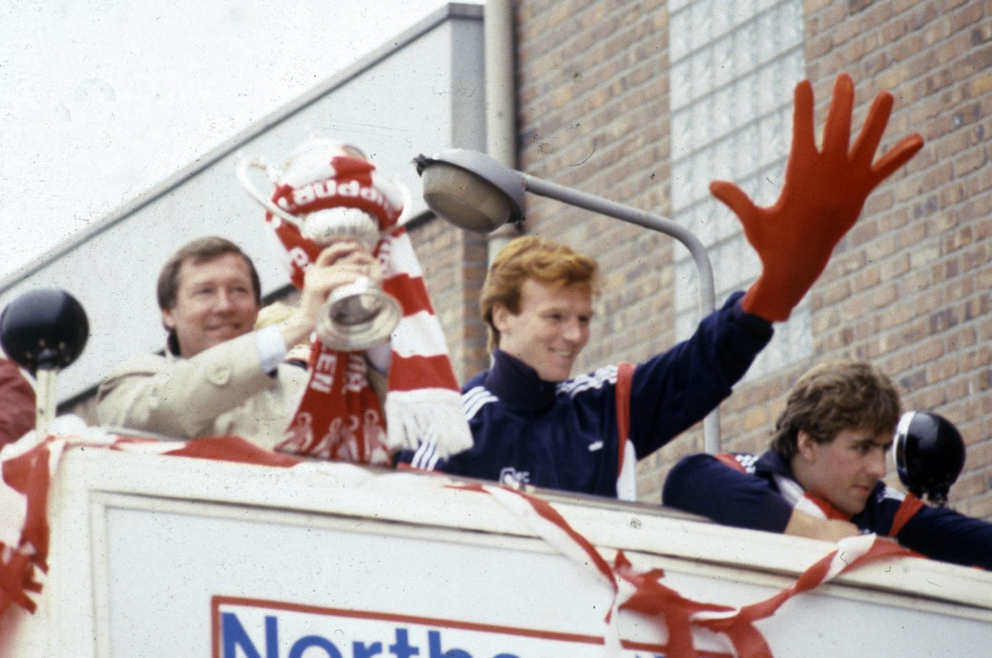 Alex Ferguson with the Scottish Cup IN 1984 with Alex McLeish and Mark McGhee on the bus outside Pittodrie. Image: Aberdeen Journals