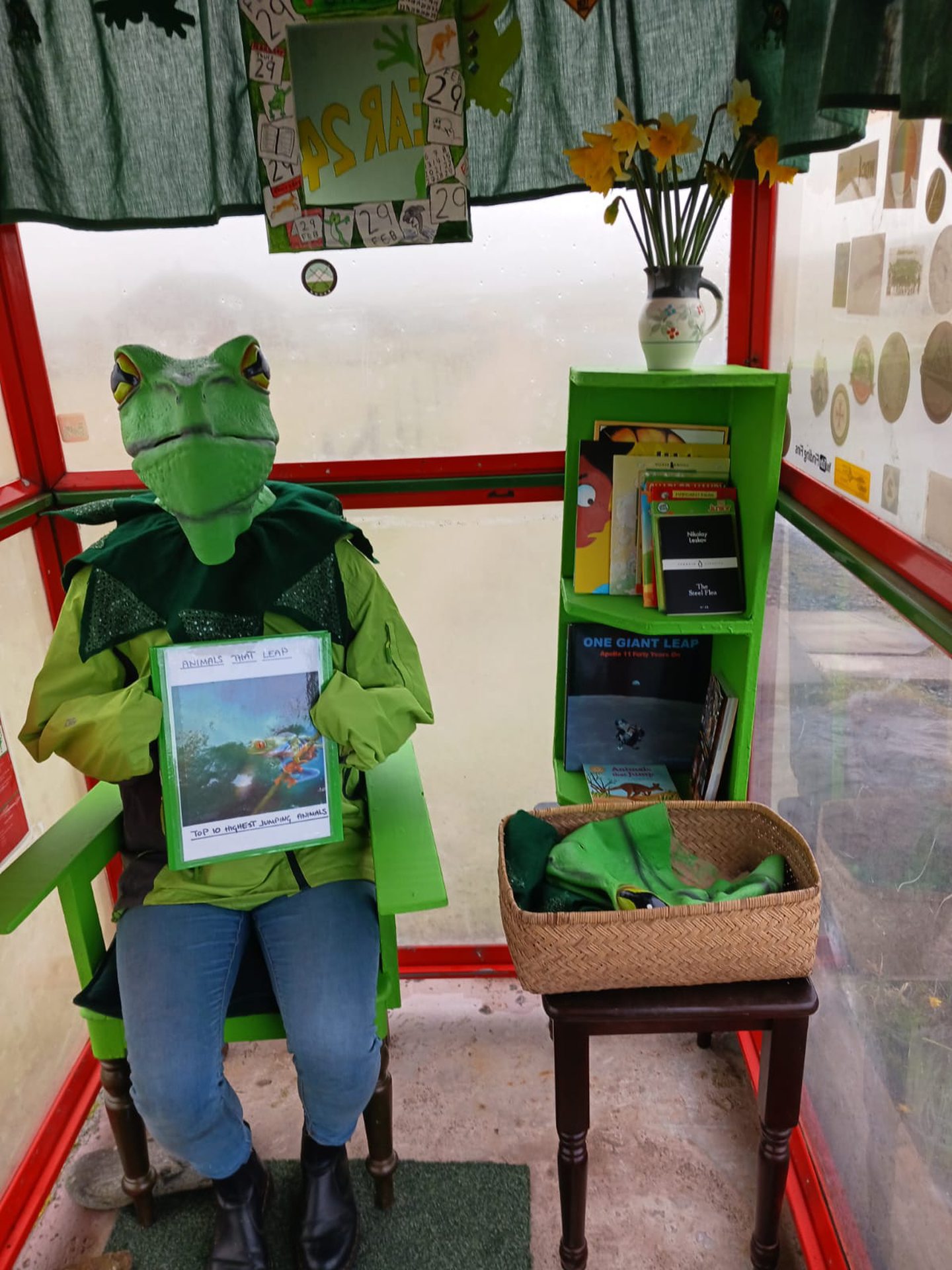 Person with a frog mask in Bobby's Bus Shelter in Unst