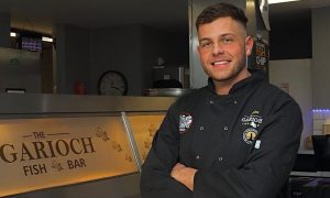 Glen at the counter of his family's chippy.