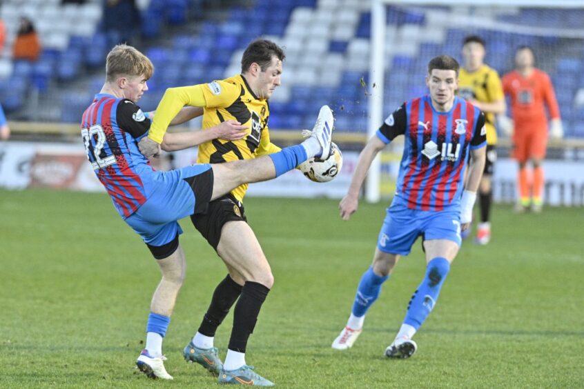 Inverness Caledonian Thistle defender Keith Bray, left, competes for the ball in his team's 2-0 SPFL League One win against Dumbarton at the Caledonian Stadium, Inverness, on Saturday, January 4, 2025. 