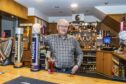 Chairman Rob Petrie behind the bar at the Seaforth Club in Elgin. Image: Jason Hedges/DC Thomson