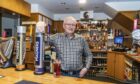 Chairman Rob Petrie behind the bar at the Seaforth Club in Elgin. Image: Jason Hedges/DC Thomson