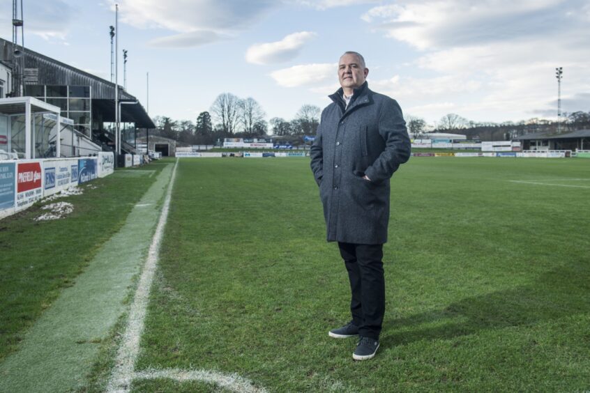 Elgin City chairman Alan Murray standing on the pitch at Borough Briggs.