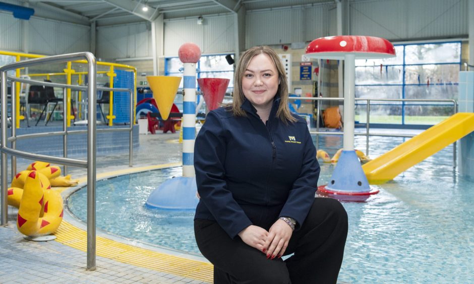 Alexandrea Macleod sitting next to Moray Leisure Centre pool. 