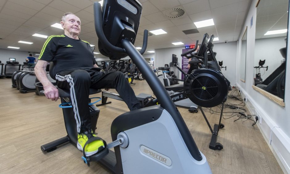 Jock Savage on cycling machine in gym. 