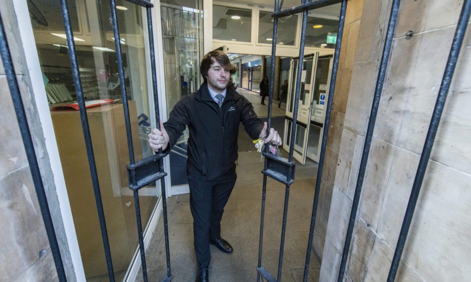 St Giles Centre gates being locked by security guard. 