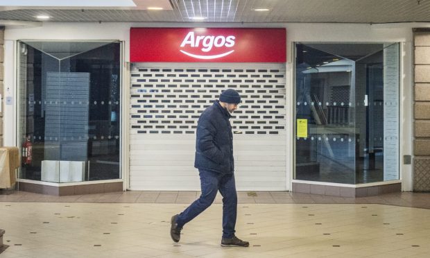 Shopper outside Argos in St Giles Centre.