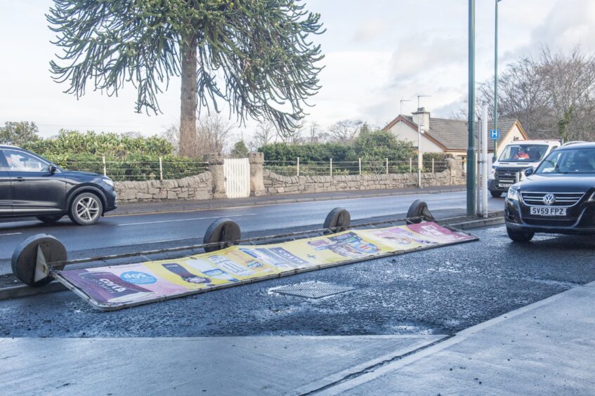 Sign blown over in Elgin 