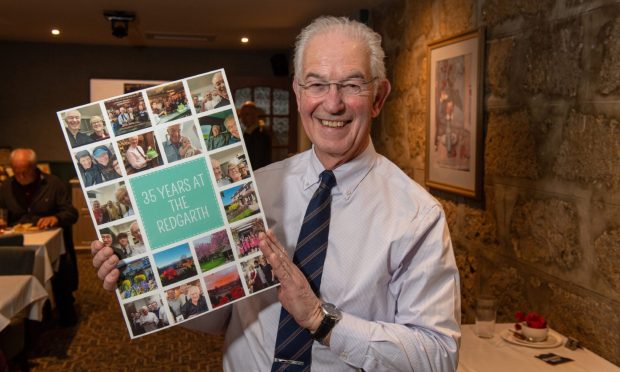 Stuart Singer with a huge card marking his 35 years at the Redgarth.