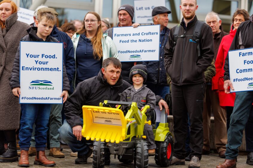 Russell Rennie with his young son, Alex, at a previous farming protest. 