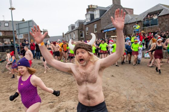 A mad run to the cold water at Stonehaven Harbour. Image: Kami Thomson/DC Thomson