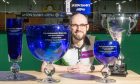 World champion Jason Banks in the newly renamed Jason Banks Arena at Garioch Indoor Bowling Centre in Inverurie. Jason is pictured with his trophies from left to right: The World Championship mixed pairs trophy, the World Championship singles trophy, the World Championship pairs trophy and the Scottish Open singles trophy. Pictures by Kami Thomson/DC Thomson.