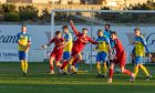 Lewis McAndrew, centre with arm raised, celebrates scoring for Lossiemouth against Strathspey Thistle. Pictures by Jasperimage.