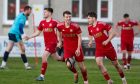 Lossiemouth's Shaun Cameron, right, celebrates scoring their second goal against Strathspey Thistle. Pictures by Jasperimage.