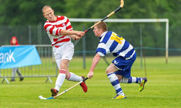 Lochaber's Lachlan Campbell (left) in action against Newtonmore in the 2012 MacTavish Cup final.  Image: Neil Paterson.