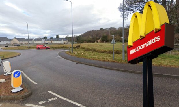 A picture of the North Kessock roundabout with a McDonalds "Golden Arches" sign in the foreground