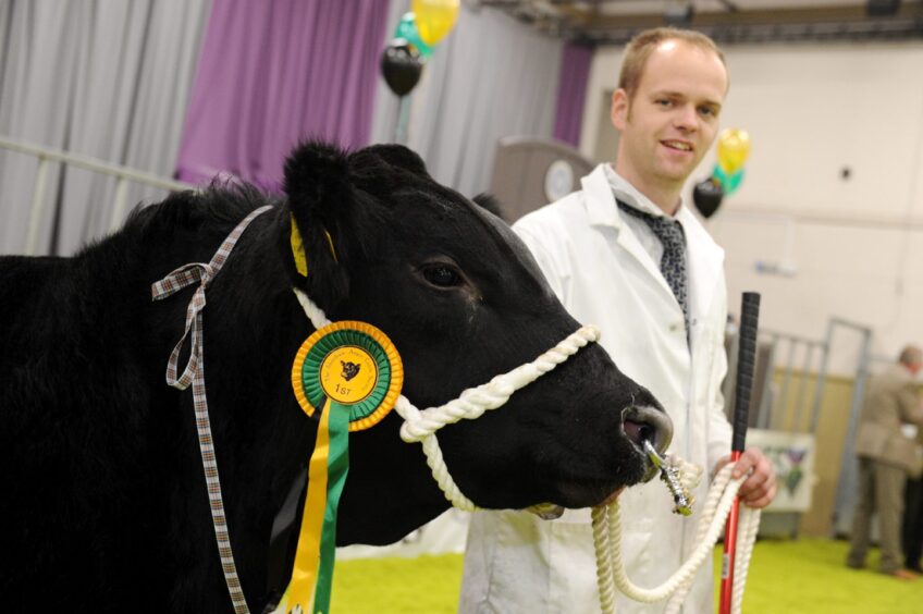 Jamie with one of his farm's champion bull calves at Thainstone, near Aberdeen, in 2014. 