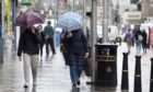 People walking with umbrellas in Inverness.