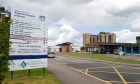 Raigmore Hospital with a welcome sign to the left.