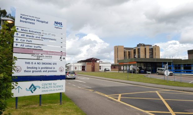 Raigmore Hospital with a welcome sign to the left.