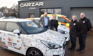 (Left to right) Fraser Bryce of Dicksons, Jodie McCluskey of Mikeysline, Gordon Scott and Sandy McPhail of Highlands and Islands Blood Bikes. stand beside three vehicles being donated to charity.