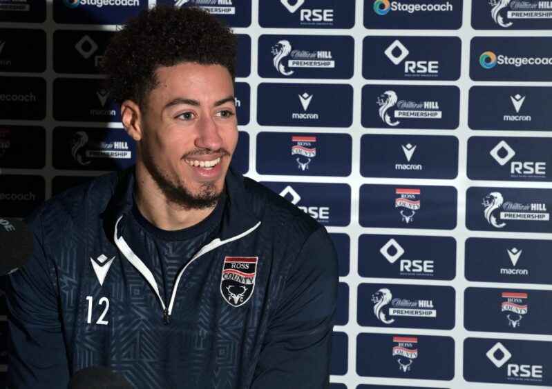 Jonathan Tomkinson smiling during a Ross County press conference.