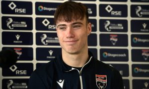 Young Ross County forward Calum Brown smiling during a press conference.