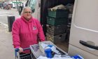 Debi Weir packing stock into van from shopping trolly.