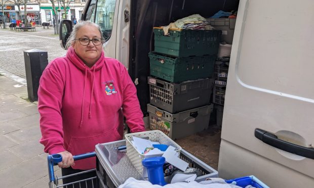 Debi Weir packing stock into van from shopping trolly.