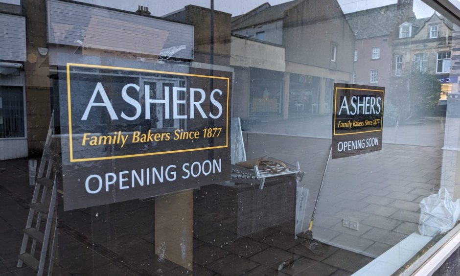 Ashers signs in shop window. 