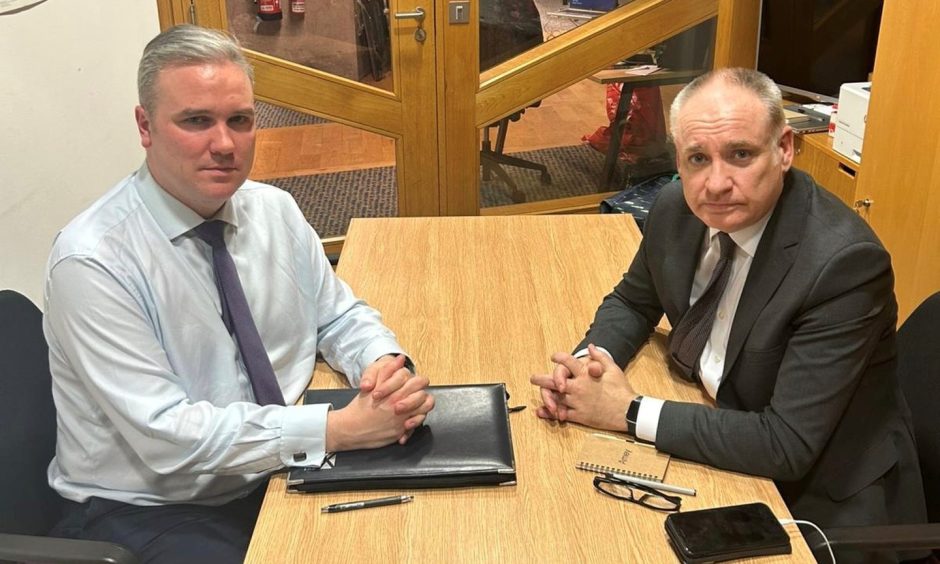 Tom Arthur and Richard Lochhead both sitting at desk. 