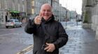 Football thug Robert Alexander gives a thumbs up as he leaves court. Image: DC Thomson.