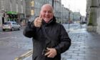 Football thug Robert Alexander gives a thumbs up as he leaves court. Image: DC Thomson.