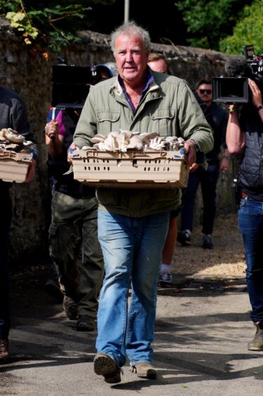 Clarkson carrying mushrooms at the opening of his pub,