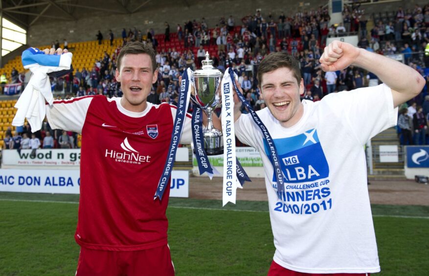 Scorers Andrew Barrowman, left, and Iain Vigurs celebrate with the Challenge Cup after Ross County's 2-0 win against Queen of the South in the final of the competition at McDiarmid Park, Perth, on April 10, 2011. 